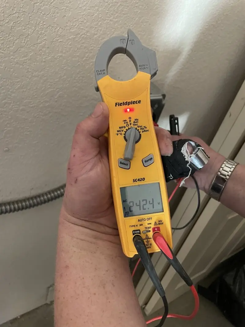 Voltage testing with clamp meter during Recessed Lighting Installation in Babylon